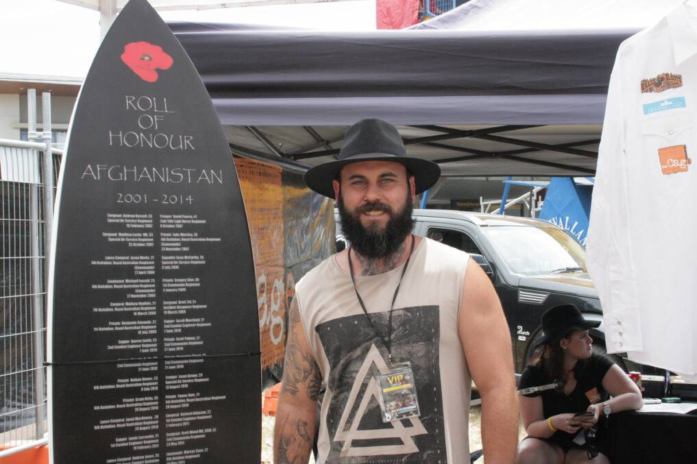 FUNDRAISING: The Cage's Paul Bowers with his handcrafted surfboard, to be raffled off in support of Young Veterans Redlands.