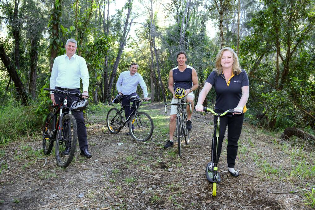 FULL STEAM AHEAD: Local Government Minister Stirling Hinchliffe, Logan MP Linus Power, mayor Darren Power and lifestyle chair Cr Laurie Koranski on the future rail trail at Wandearah Road and Railway Parade, Logan Village.
