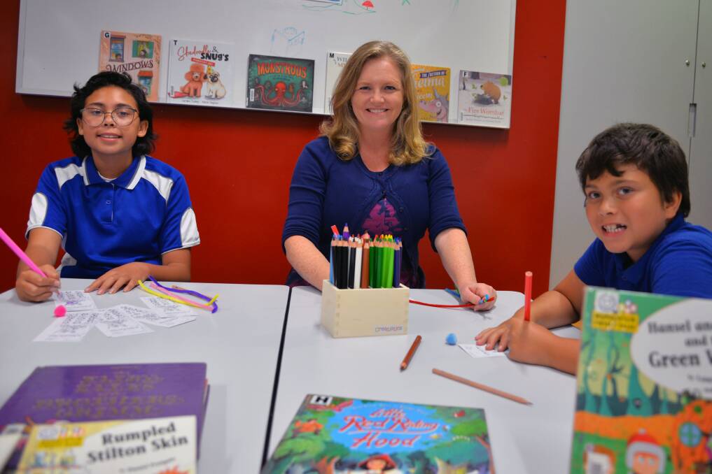 FUN AND MAGIC: Logan City Council City Lifestyle Committee chairperson councillor Laurie Koranski samples some of the fun of the annual Summer Reading Program with Logan siblings Joy Lewis (left) and Stevie Lewis.