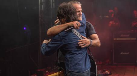 TOGETHER AGAIN: Jon Stevens and Steve Balbi embrace at Noiseworks first show in seven years.