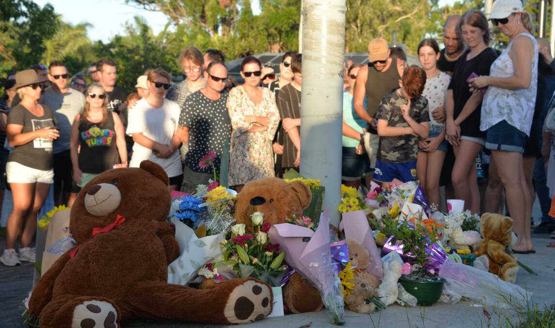COMMUNITY GATHERS: Part of the large crowd at the corner of Allenby and Finucane roads.