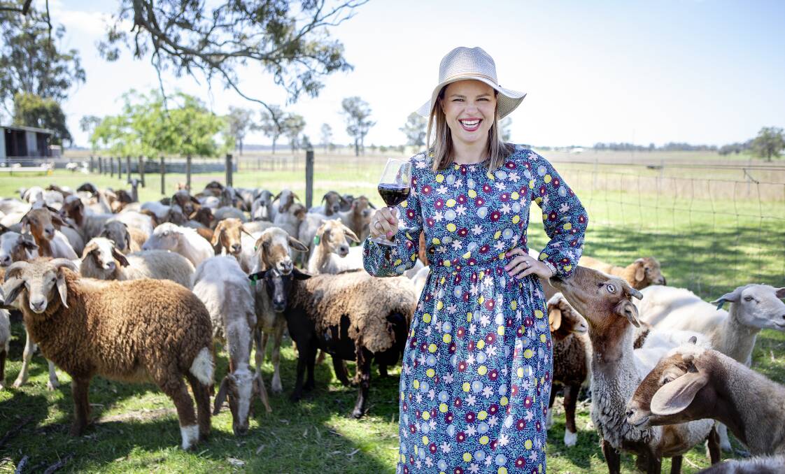 FUN DAY OUT: Scenic Rim local Emily Lochran enjoys a glass of red in the paddock. Photo: supplied