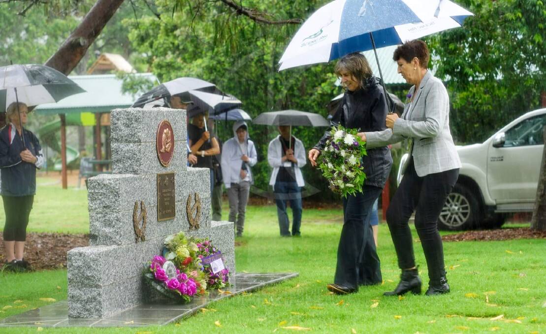 RESPECT: Nadia O'Carroll and Virginia West lay a wreath at the Canungra animal memorial. Photo: Katherine O'Brien