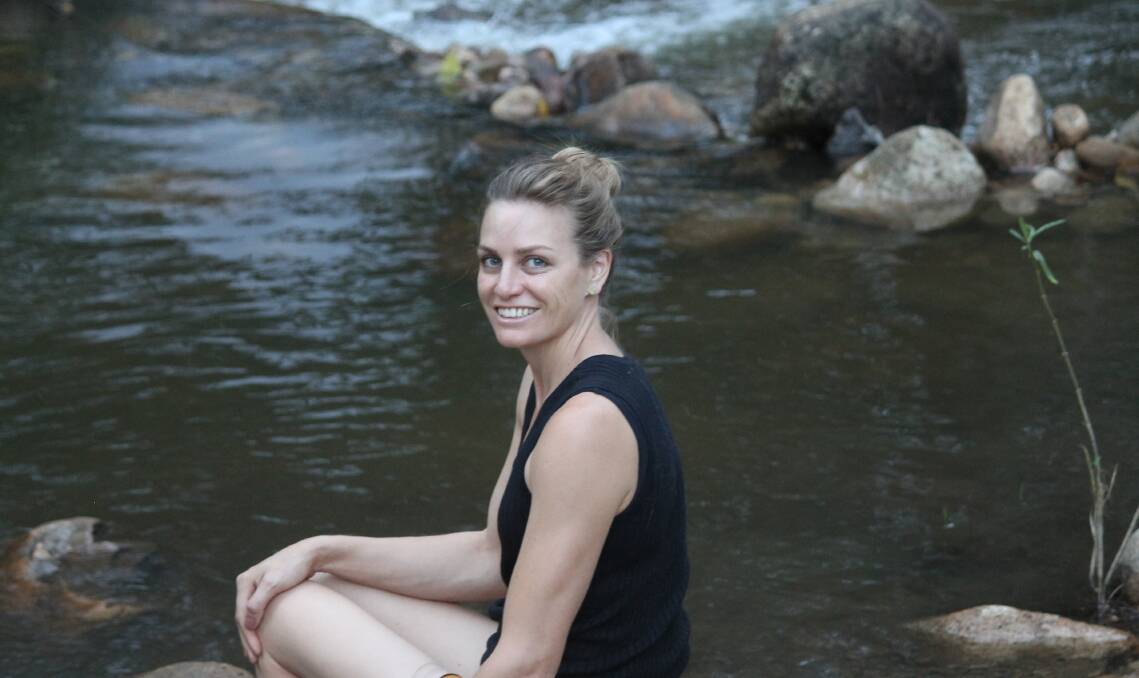 CHILLED: Megan Radloff cools off and chills out in the clear waters of the creek at Mount Barney Lodge in January.