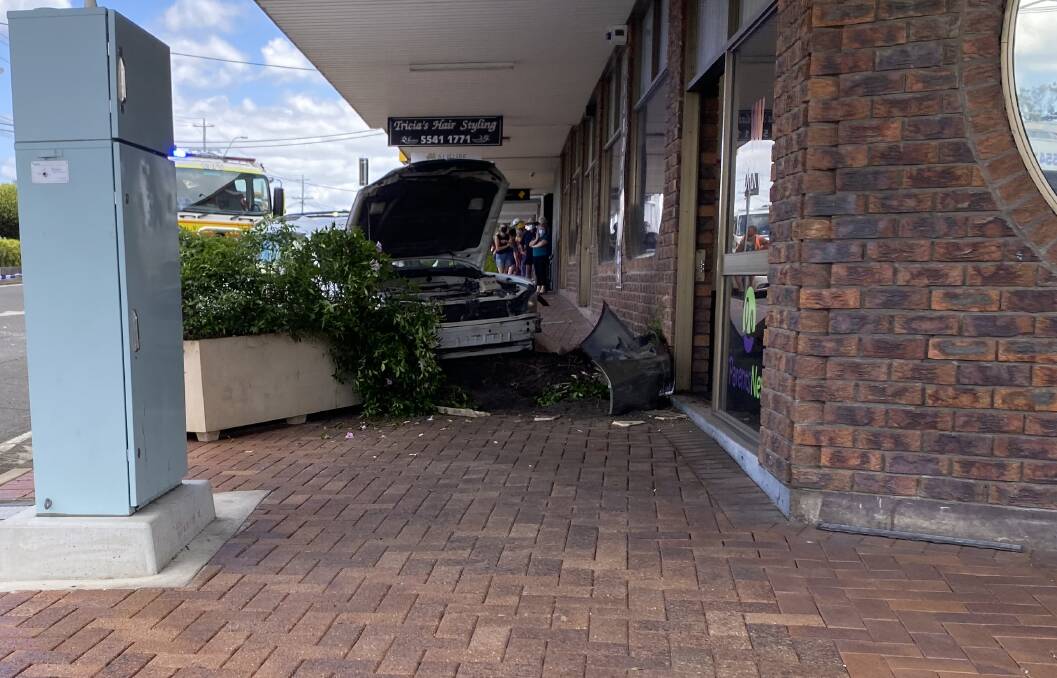 CAR CRASH: A vehicle has crashed into shops on Brisbane Street. Photo: Ken Nicklas
