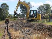 Crews ripping up railway tracks near Helen Street in 2016 to make way for the Beaudesert bypass.