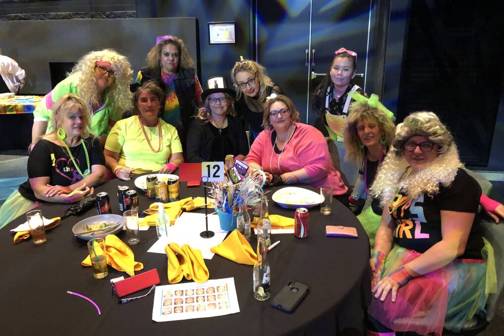 TIME WARP: The Beaudesert Coles team at the fundraiser.