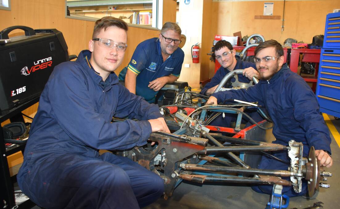 BURN RUBBER: Automotive and engineering teacher Jasen Johnson with Grade 12 students Riley Hart, Ben Ayling and Riley Morgan with their race car.