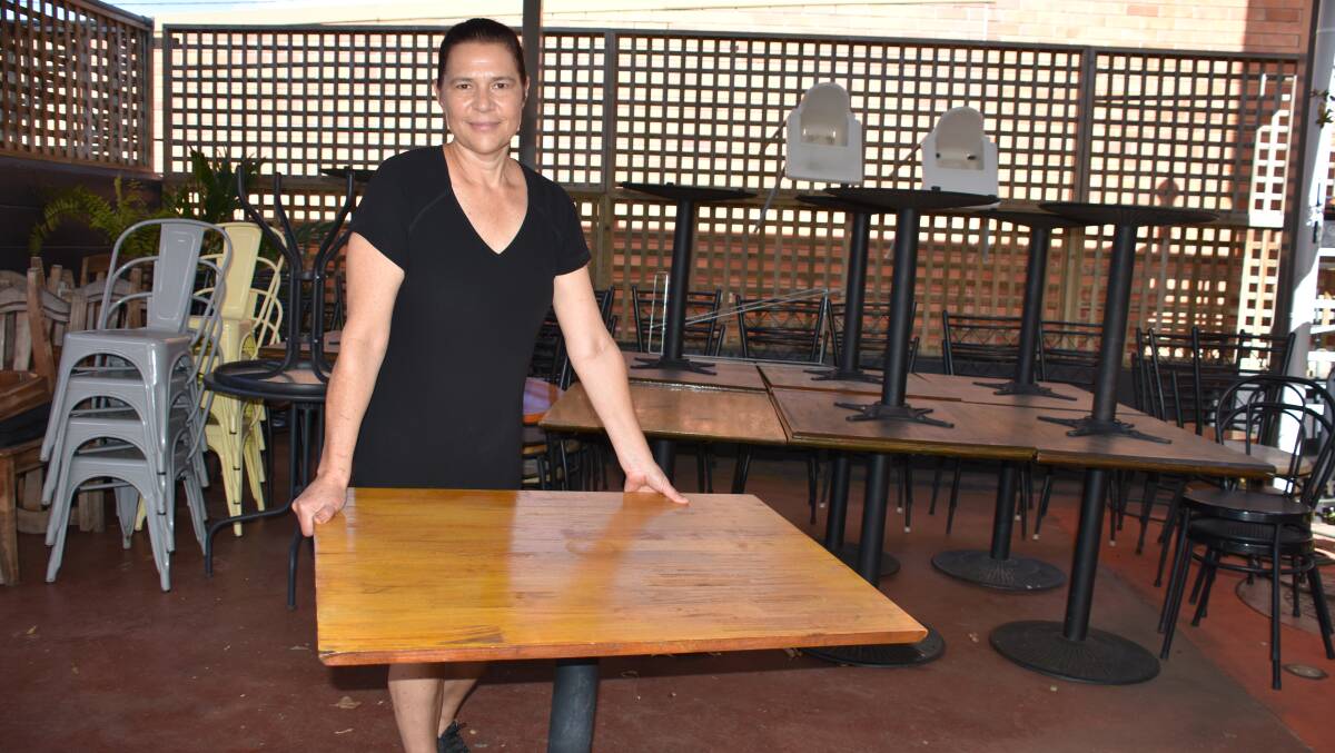 SET UP: Everydays Cafe and Coffee House owner Toni Cooper sets up tables for 10 patrons ahead of Saturday's reopening.