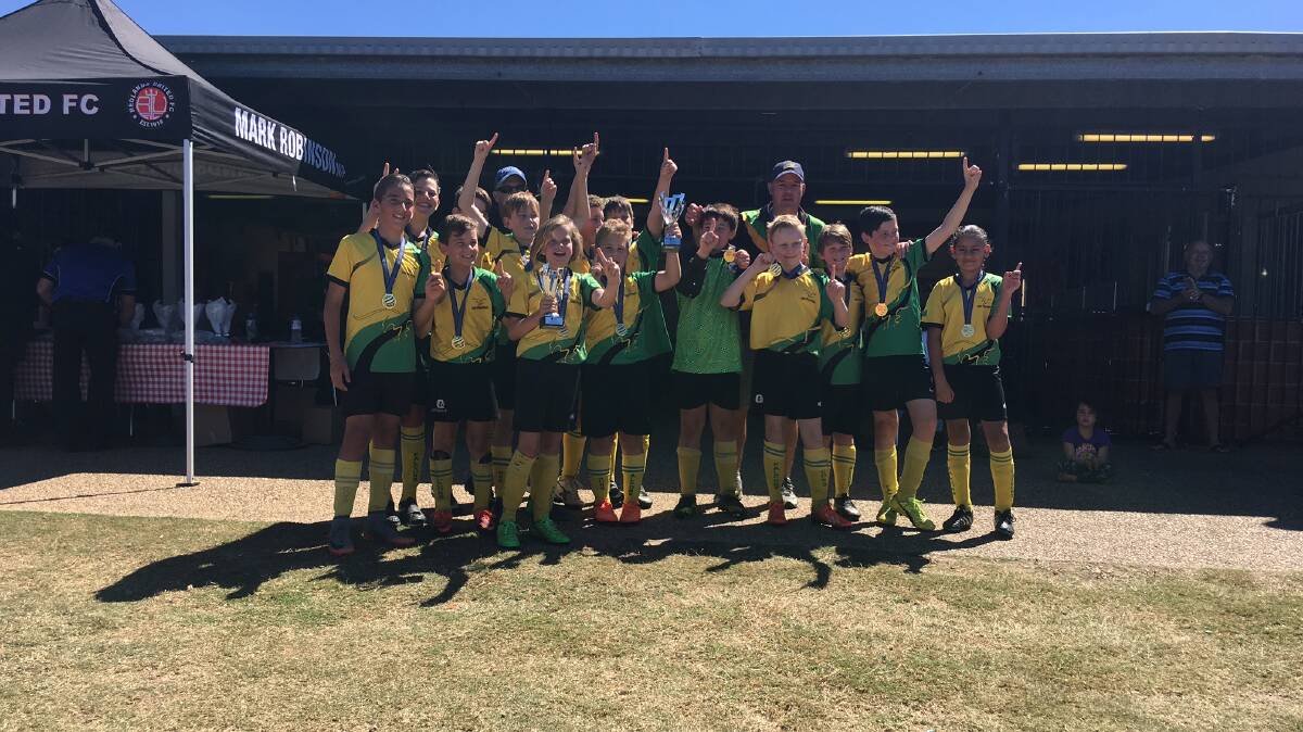 We are the champions: Logan Village Falcons under 12s celebrate their grand final victory over Annerley. Photo: Supplied