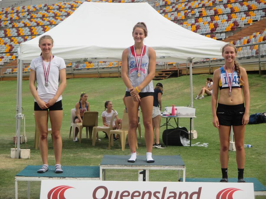 Camryn Newton-Smith atop the podium after winning the u18 girls 100m hurdles with second placed Kasja Souter (left) and bronze medallist Anthea Moodie

 