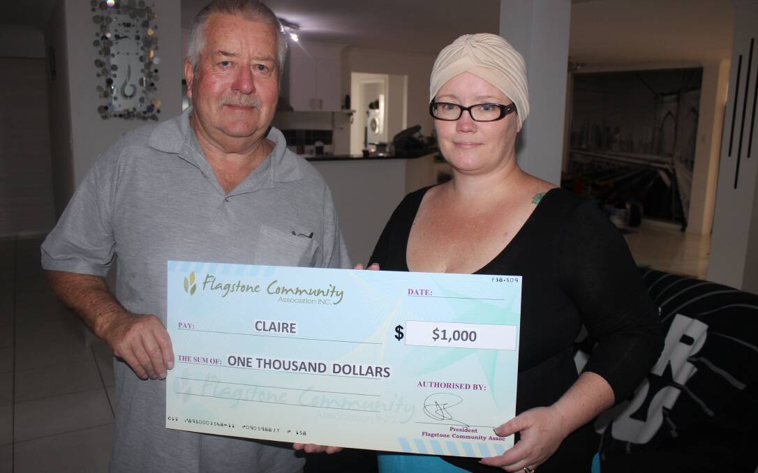 Flagstone Community Association's Bob Wiley presents Claire Wilkinson with a cheque for $1000 to help her in her quest to get to the UK for further medical treatment.