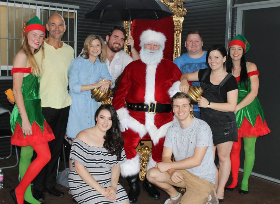 THEY WILL BE BACK: Footlights Theatrical, pictured with Santa and his elves, will be back to sing at Carols in the Parklands at Yarrabilba on December 22. Photo: Cheryl Goodenough