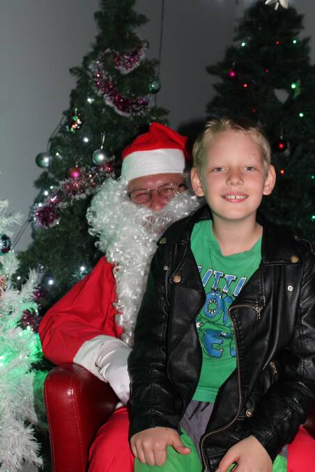 ALL SMILES: Silvan Daley was happy to smile with Santa at Claire Wilkinson and David Rochford's home at Flagstone. Photo: Claire Wilkinson 