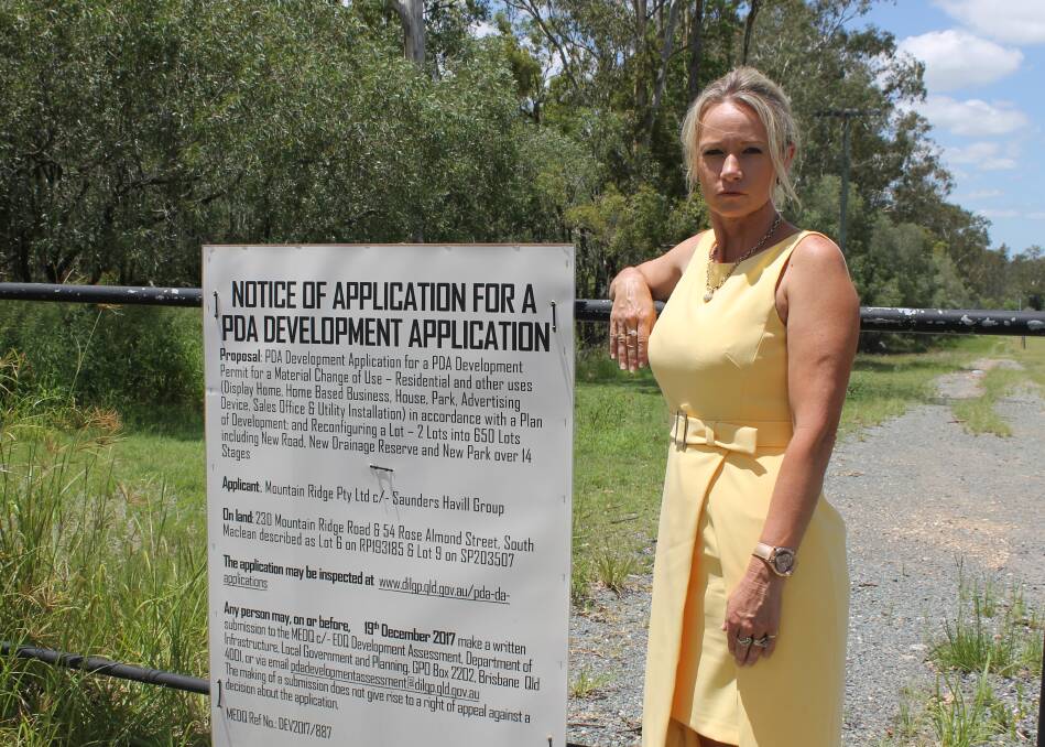 PROPOSED DEVELOPMENT: Councillor Trevina Schwarz at the entrance to land on Mountain Ridge Road where a 650-lot development is proposed. Photo: Cheryl Goodenough