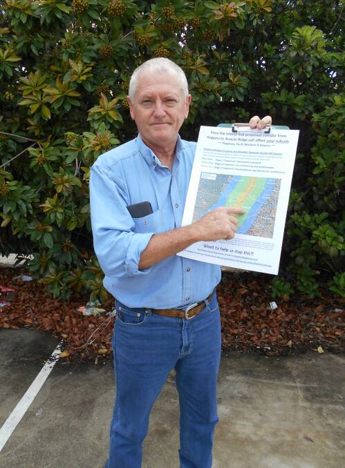 CONCERNED: Wayne Gorman says he is concerned the lifestyle of Flagstone residents will be negatively impacted by the Inland Rail project. He holds a picture showing areas near the line that could be affected by the trains.