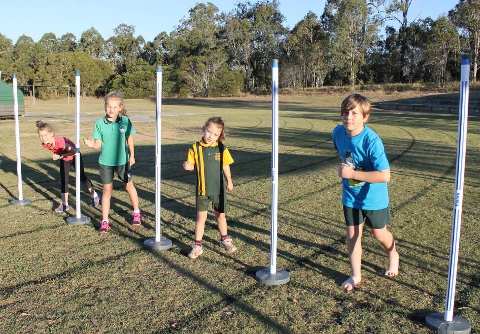 Little athletes Tahlia Seymour, 8, Bella Bess, 8, Suma Girard, 5, and Hayden Lovasz, 10, tried out the new electronic timing gates on Wednesday night.