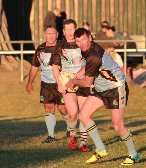 A old boys player gets set to unload the ball.