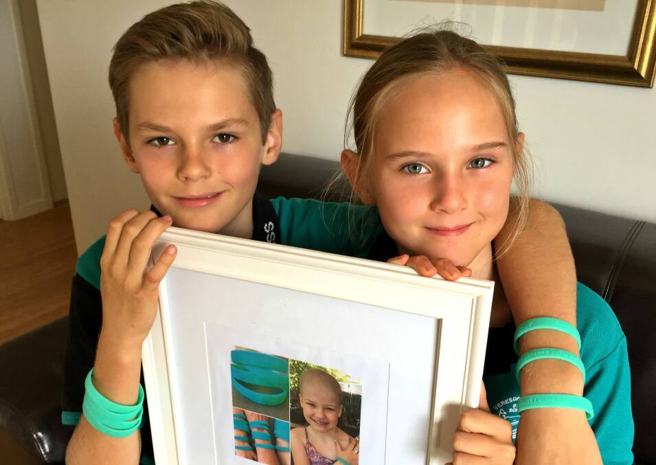 Sammy and Daisy Pearce have raised more than $8,000 by selling wrist bands, which will be donated to the Hews family. Photo: Louise Starkey