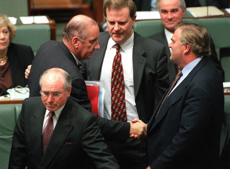 Well done: Then Labor leader Kim Beazley congratulates Tim Fischer on his career in politics in June 1999 as treasurer Peter Costello watches on and prime minister John Howard stands in the foreground.