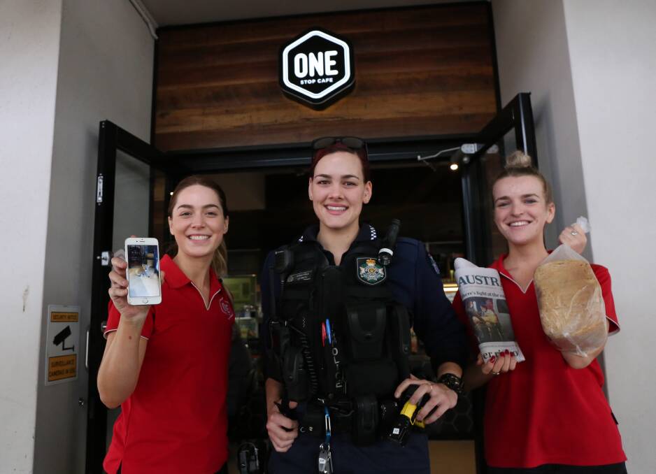 MORNING JOB: One Stop Cafe staff member Teagan Thompson, Cleveland police officer Constable Liv Smith and staff member Tayla Branch began their morning with a koala encounter. Photo: Jocelyn Garcia