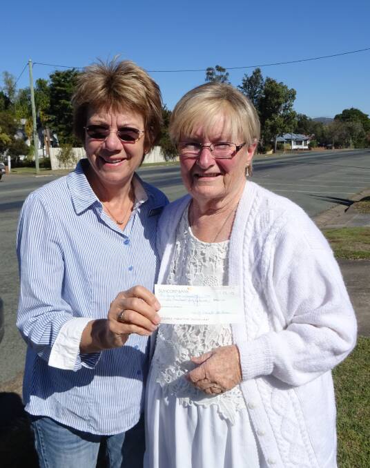 CORALYN'S CHEQUE: Coralyn Cowin (right) with the cheque she gave to Cancer Council Beaudesert president Ellen Logan. Photo: Supplied