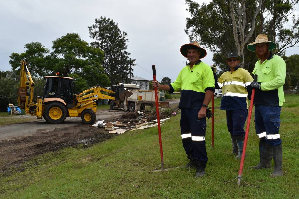 BIG EFFORT: Logan City Council crewmen Stephen Powley, Milton Parker and Dale Simpson visited sites to collect piled rubbish and debris. Trucks, excavators and traffic controllers were also involved in the task.  Photo: Hannah Baker