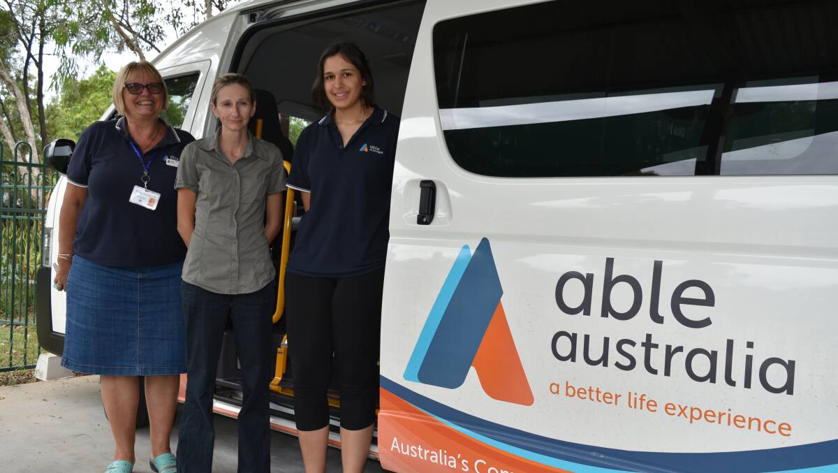 HELPDING HANDS: Driver Ingrid Werner, transport officer Victoria Barrett and business trainee Jenai Kussrow stand in front of the Able Australia passenger van, which is deployed from Caddies Community Centre. Photo: Hannah Baker
