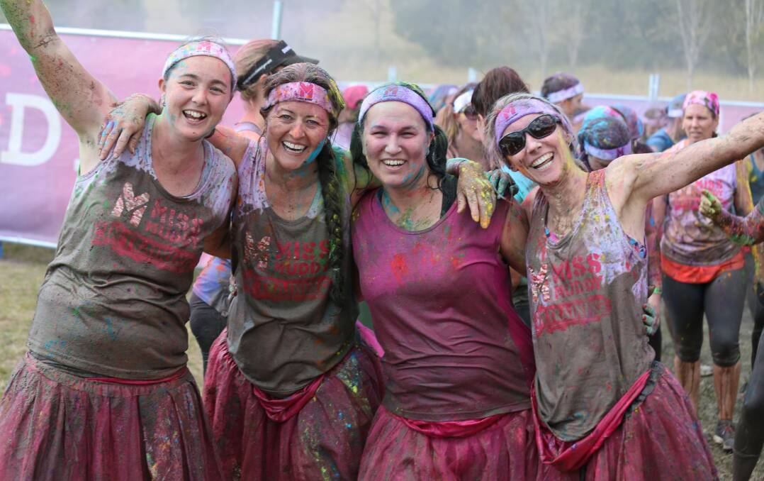 SMILES: Laura Forrester, Tracey Luxford, Biana Green and Siobhan Graham, of Greenbank, get dirty and colourful in Miss Muddy.
