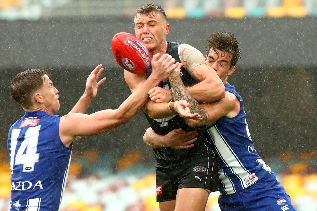 Carlton's Patrick Cripps is tackled during the match against North Melbourne at The Gabba on Saturday. Photo: Jono Searle/Getty Images