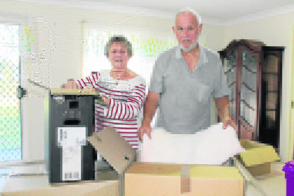 Helen and Owen Anderton packing the last of their belongings to move from the house Main Roads bought from them  
to make way for the future Park Ridge Connector road.
