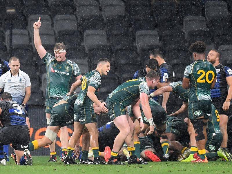The Wallabies celebrate Michael Hooper's try against Argentina in the rain at Bankwest Stadium.