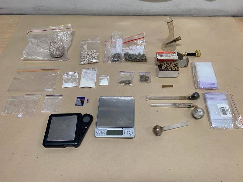 Drugs, utensils and cash were found in the raid of a Kingston residence on Monday.