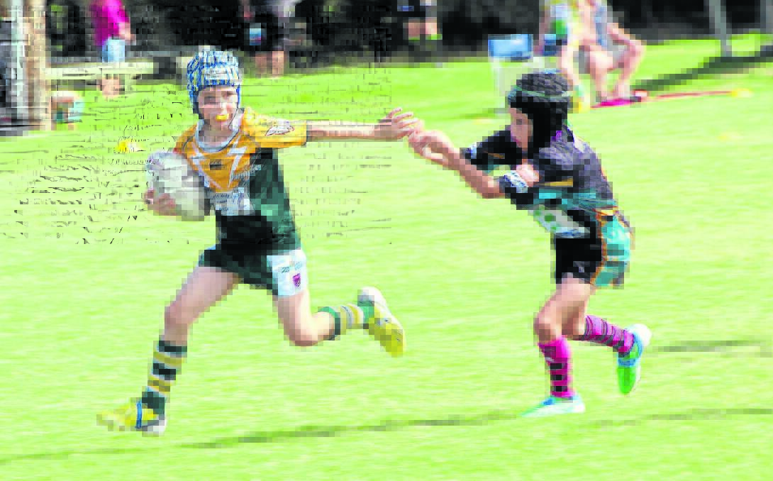 Active: Jimboomba Thunder under 8s player Chase Denaro running with the ball. Kids in south-east Queensland can get help accessing their favourite sport thanks to government program.