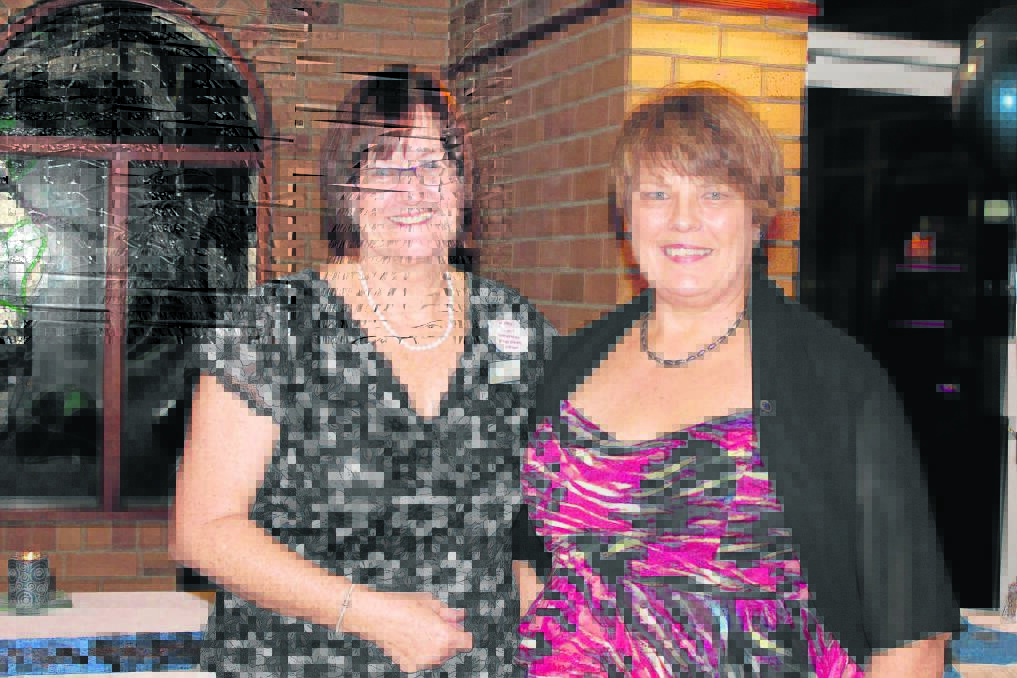 Quota International district governor Sandy Smith welcomes new Jimboomba president Robyn Carroll.