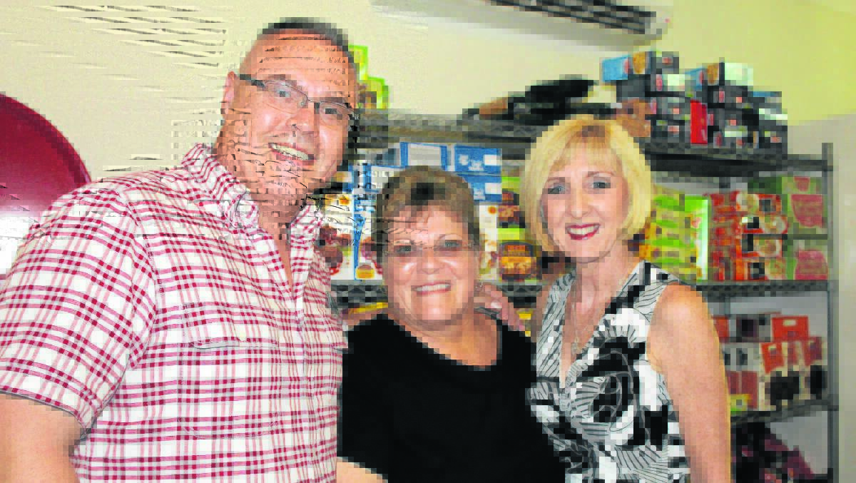 Logan MP Michael Pucci, area manager of Able Australia Jimboomba Caddies Ann Abkins and Minister for Communities, Child Safety and Disability Services Tracey Davis tour the centre's  
food pantry last Wednesday.