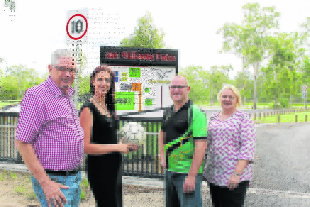 Division Four Councillor Don Petersen, LJ Hooker Yarrabilba director Christie Smith, Logan Village Falcons secretary Matt Armstrong and Logan Country Community Bank branch  
manager Kerry Menck check out the new gates, signs and car park at the Falcons' grounds.