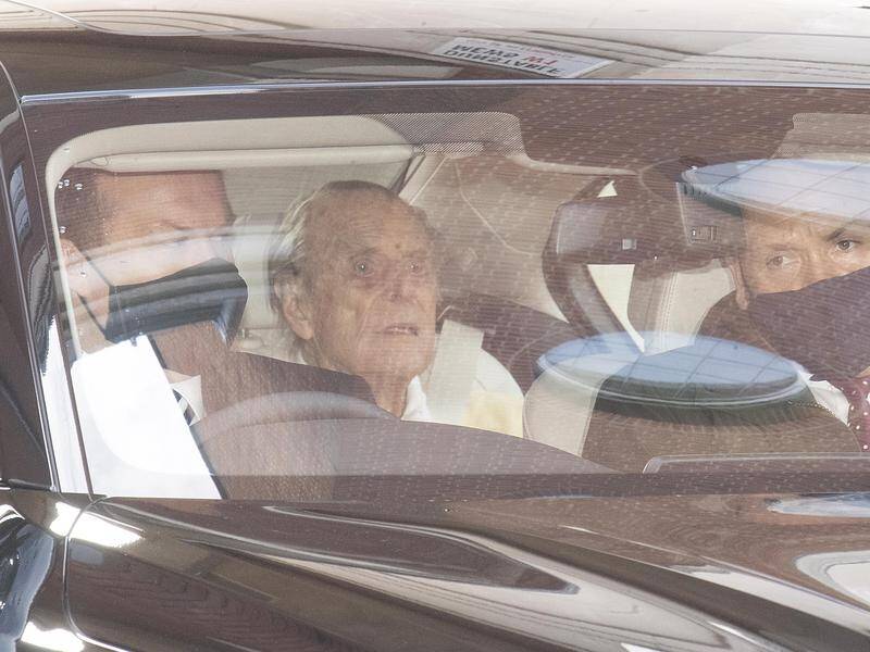 Prince Philip has been photographed sitting in the back of a car after leaving hospital in London.