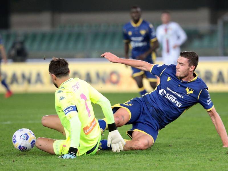 Genoa goalkeeper Mattia Perin makes a save from Verona's Andrea Favilli in Monday's goalless draw.