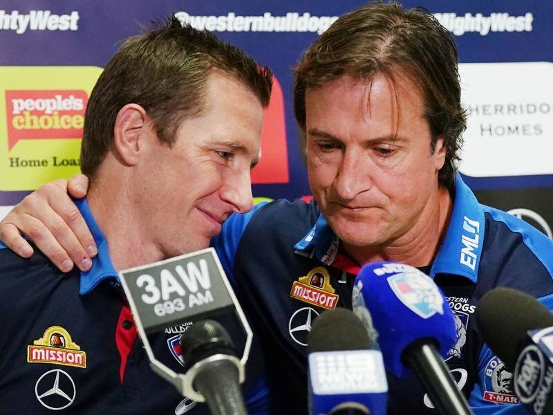 Luke Beveridge (r) has described his sadness at the departure from the Bulldogs of Dale Morris (l).