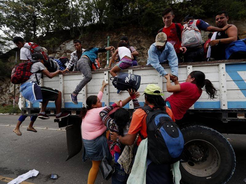 Honduran immigrants heading to the USA have boarded caravan trucks in Guatemala.