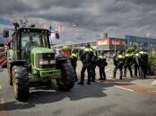 Dutch police say they had to fire shots when protesting farmers drove tractors at them.