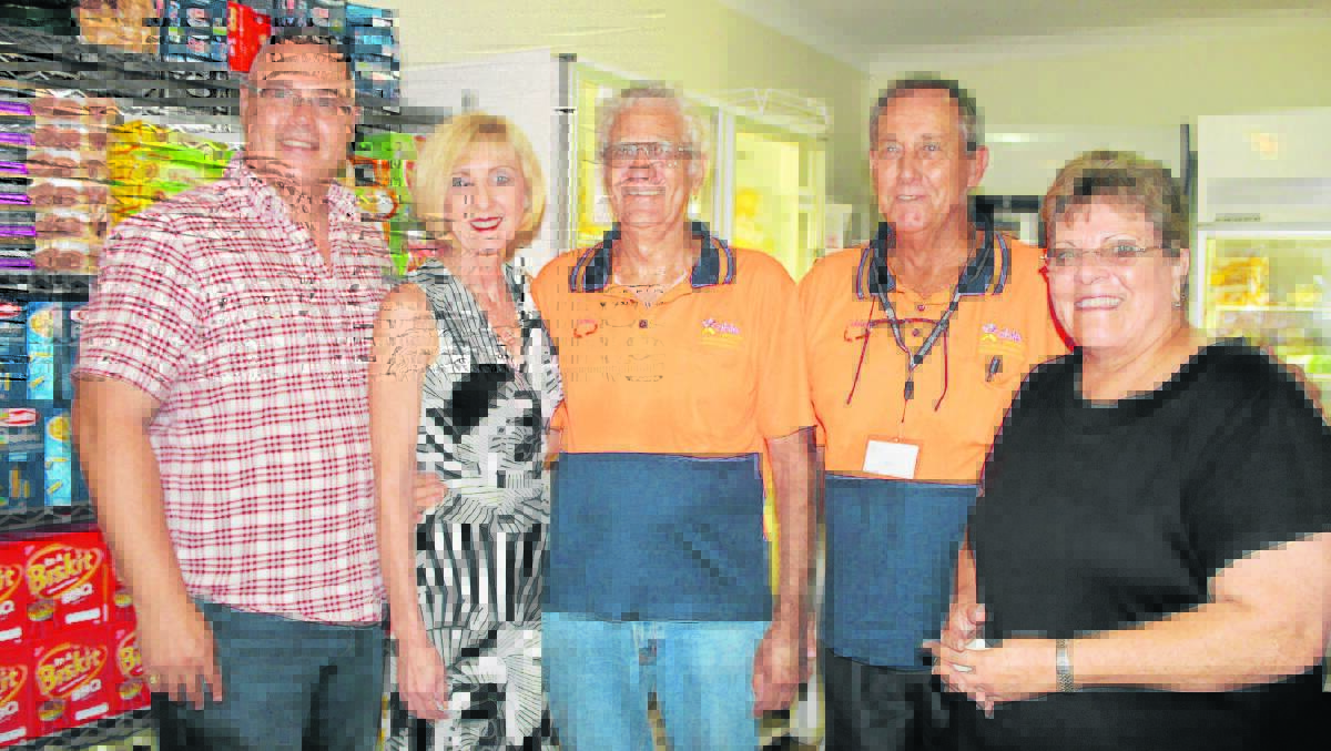 Logan MP Michael Pucci, Minister for Communities, Child Safety and Disability Services Tracey Davis, Able Australia Jimboomba Caddies volunteers Peter Bowler and Ray Connell and area manager Ann Abkins tour the centre's food pantry .