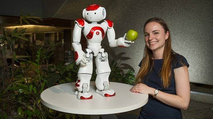 Nicole Robinson with one of the NAO robots. Photo: QUT