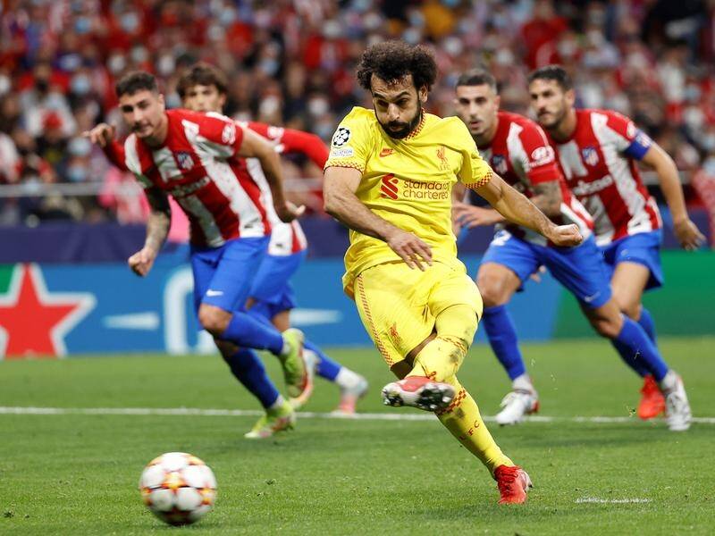 Liverpool striker Mohamed Salah scores the winning goal at Atletico Madrid from the penalty spot.
