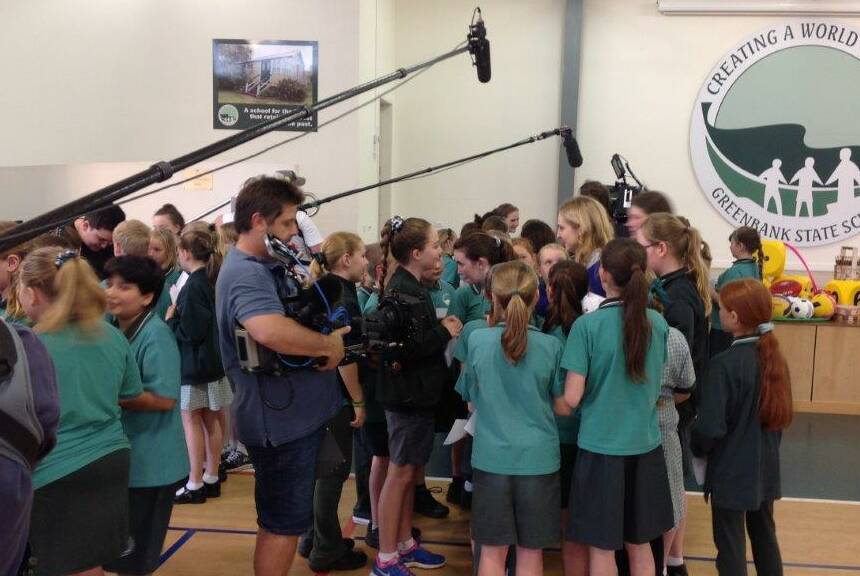 Greenbank State School students swarm the members of Team Ricky.