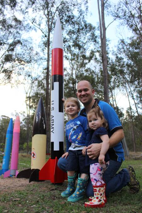 Kaleb and Piper with dad Blake Nikolic get ready for blast off at Flames, Smoke and Noise at Cedar Grove on Sunday.