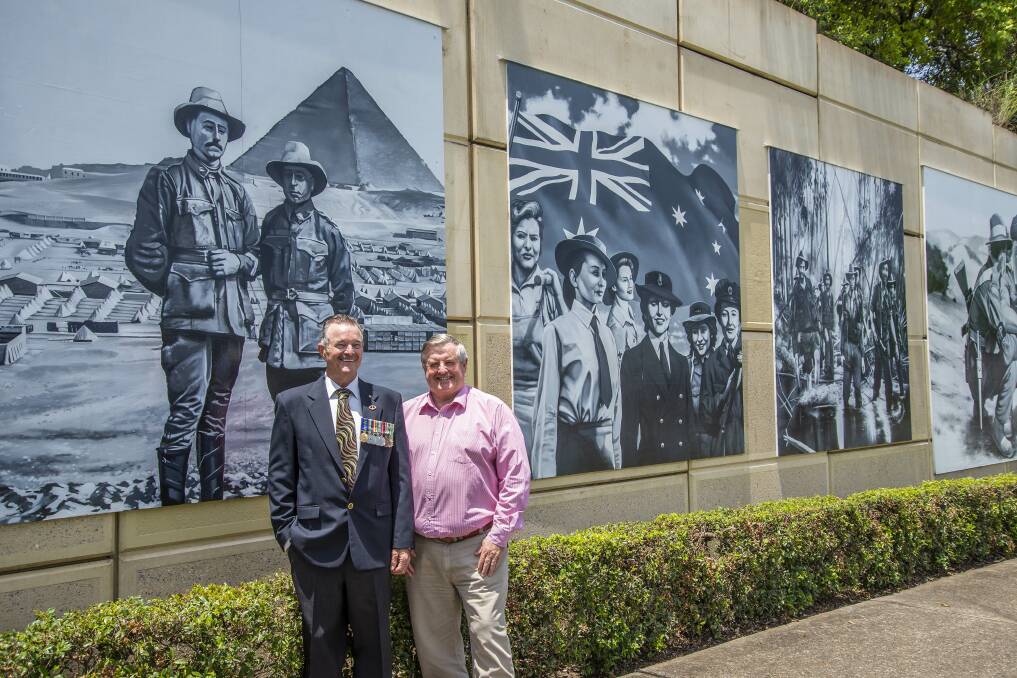 TRIBUTE: Vietnam veteran Tom McGee OAM and Cr Laurie Smith by the mural on Anzac Avenue, Greenbank. Photo: LCC