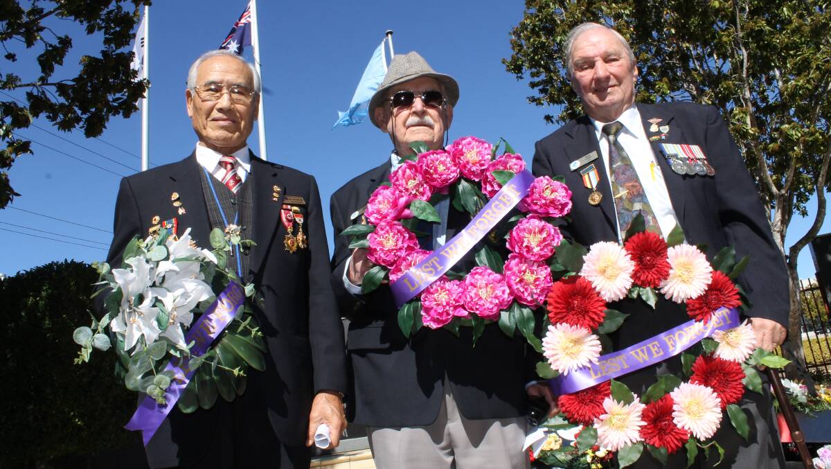 SALUTE: Paul Kim, Harry Pooley and Ron Lord snapped at Greenbank RSL in 2014.