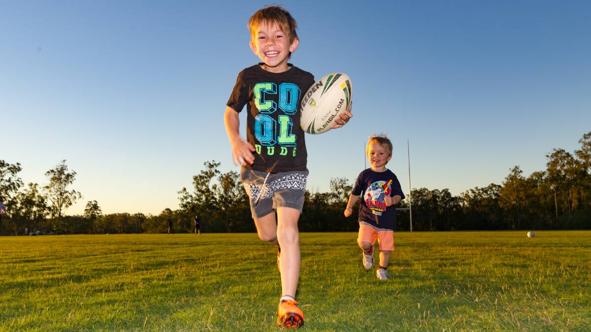 FOOTY: Travis Ritchie, 6, and brother Ryan, 3, take a run on the new Flagstone oval.